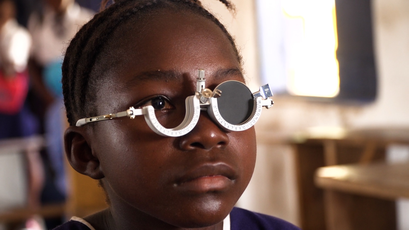 A learner being tested with an optical trial frame during a school vision screening